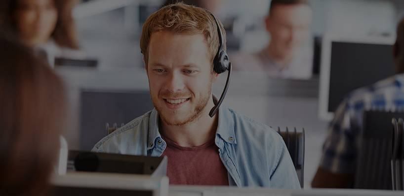 Mann telefoniert über Computer und Headset